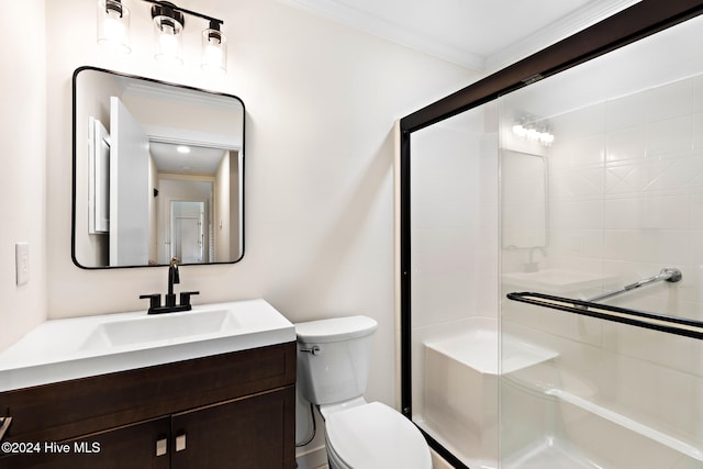 bathroom with toilet, an enclosed shower, ornamental molding, and vanity