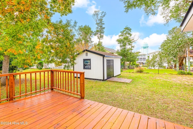 deck with a shed and a lawn