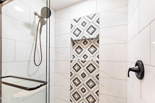 bathroom with a tile shower