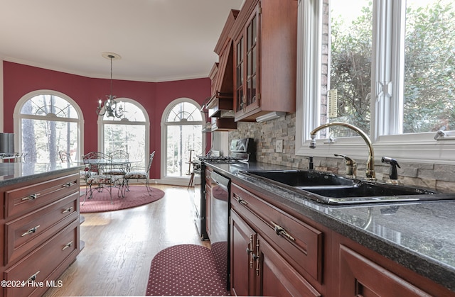 kitchen with an inviting chandelier, crown molding, sink, hanging light fixtures, and light hardwood / wood-style floors