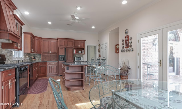 kitchen featuring a center island, light hardwood / wood-style flooring, crown molding, and black appliances