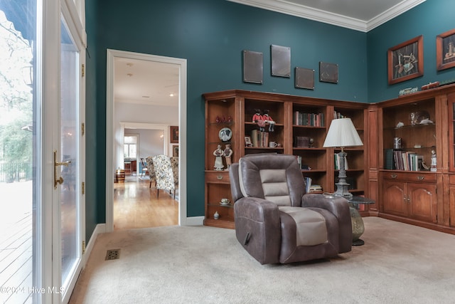 sitting room with ornamental molding, carpet floors, and a healthy amount of sunlight