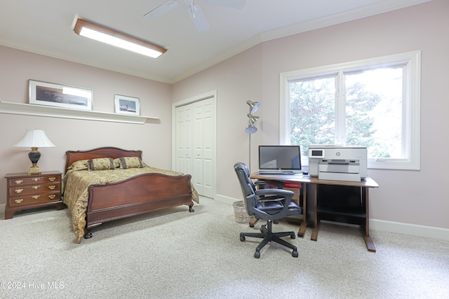 bedroom featuring ceiling fan, crown molding, and a closet