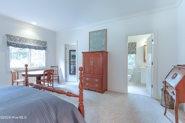 tiled bedroom with ornamental molding and connected bathroom