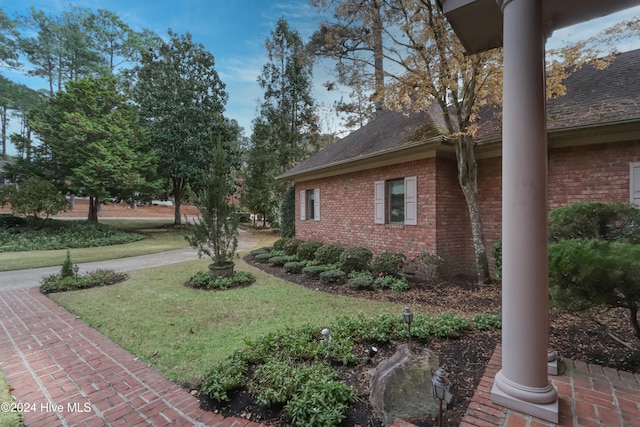 view of side of home with a lawn