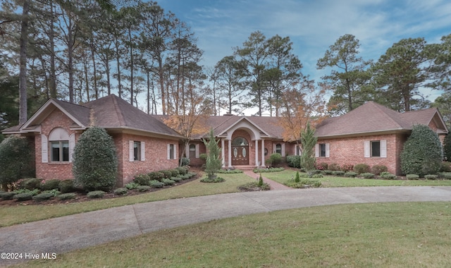 ranch-style house with a front lawn