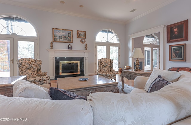 living room with french doors, hardwood / wood-style floors, and ornamental molding