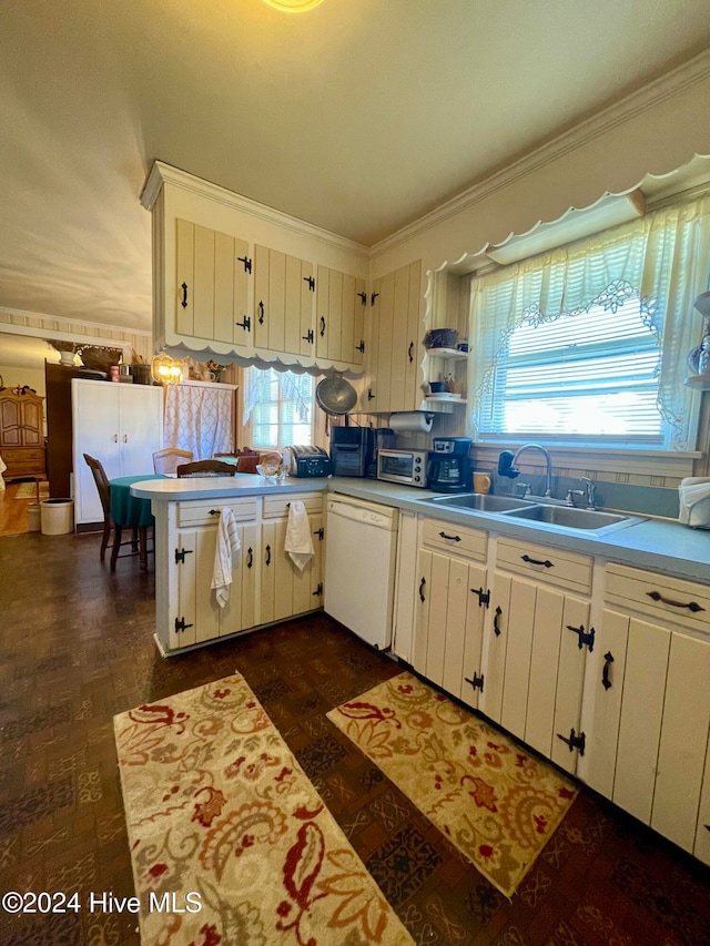 kitchen featuring dishwasher, white cabinets, a healthy amount of sunlight, and sink