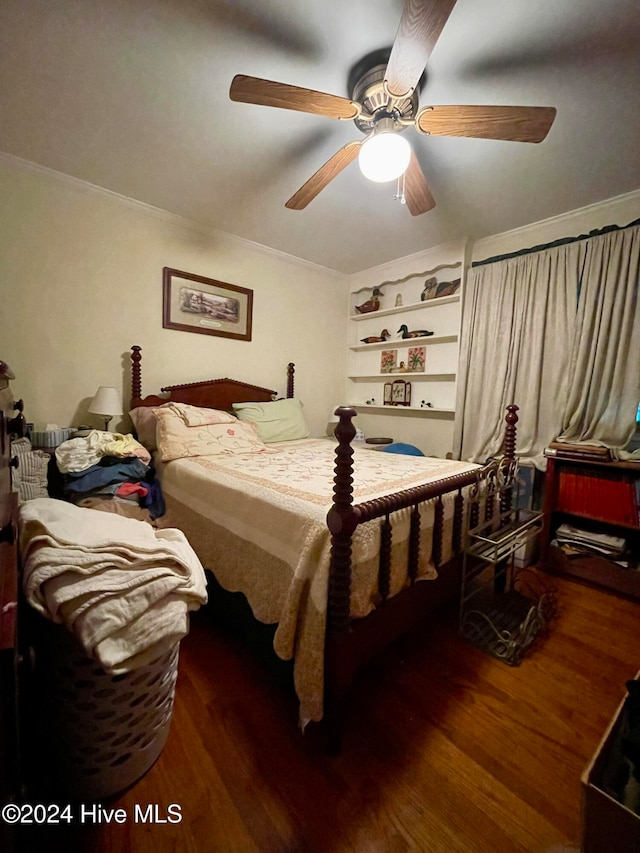 bedroom featuring dark hardwood / wood-style floors, ceiling fan, and ornamental molding