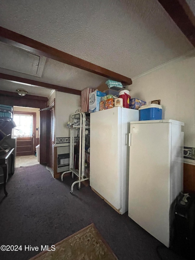 interior space with white refrigerator, carpet floors, and a textured ceiling