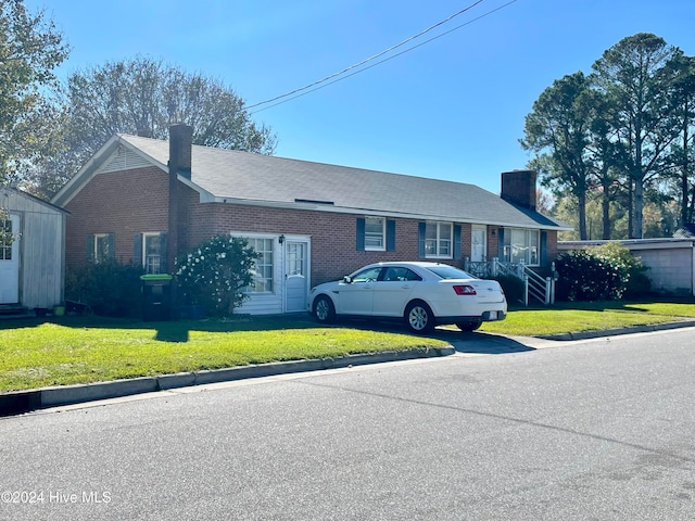 ranch-style home with a front lawn