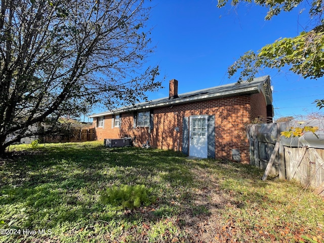 rear view of house with a lawn