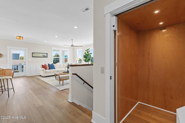 1514 Mackerel Ln, Carolina Beach, NC 28428 - hall with recessed lighting, a wainscoted wall, visible vents, an upstairs landing, and light wood-style floors