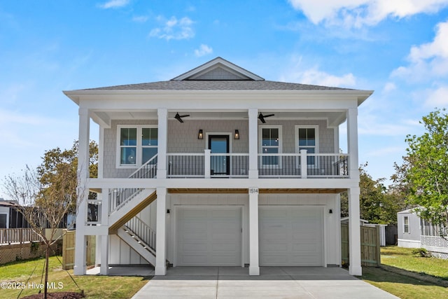 1514 Mackerel Ln, Carolina Beach, NC 28428 - raised beach house with an attached garage, ceiling fan, driveway, and roof with shingles