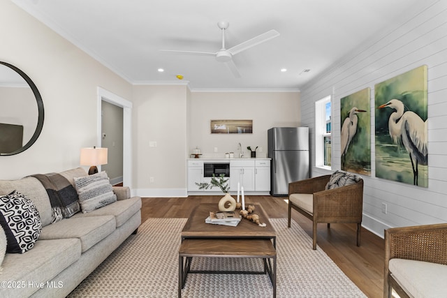 1514 Mackerel Ln, Carolina Beach, NC 28428 - living area featuring dark wood finished floors, crown molding, and a ceiling fan