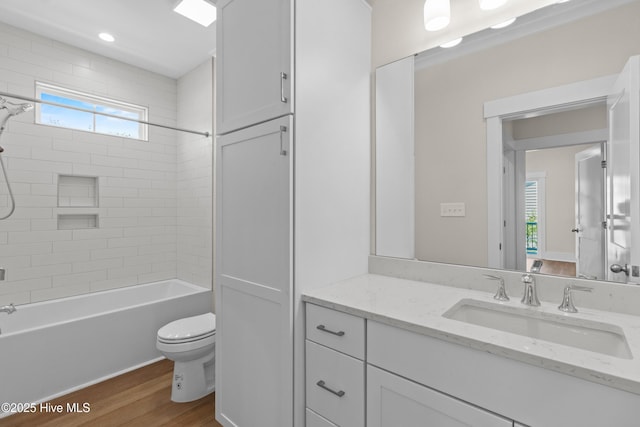 1514 Mackerel Ln, Carolina Beach, NC 28428 - full bathroom with wood finished floors, a healthy amount of sunlight, toilet, and vanity