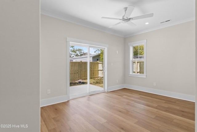 1514 Mackerel Ln, Carolina Beach, NC 28428 - empty room featuring light wood-type flooring, baseboards, visible vents, ceiling fan, and ornamental molding