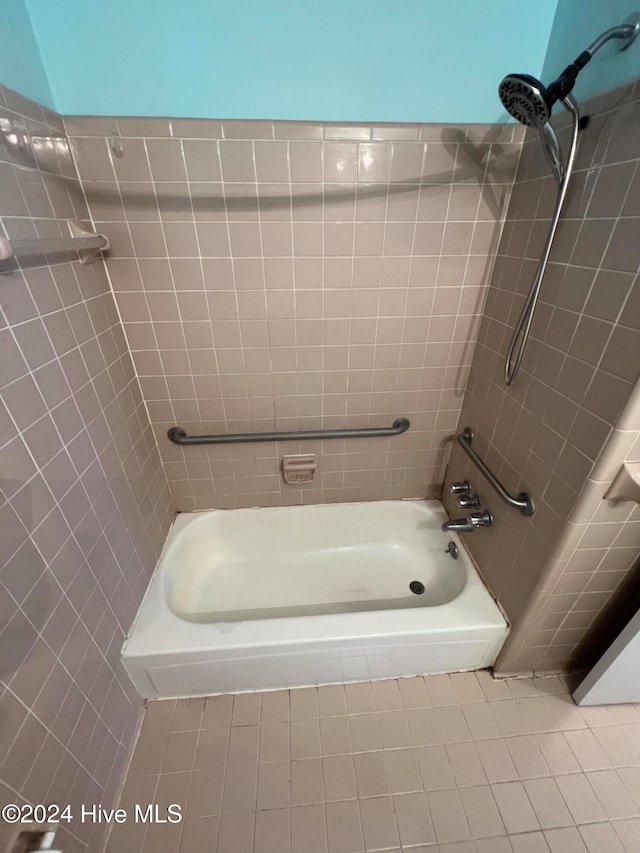 bathroom featuring tile patterned flooring and tiled shower / bath combo