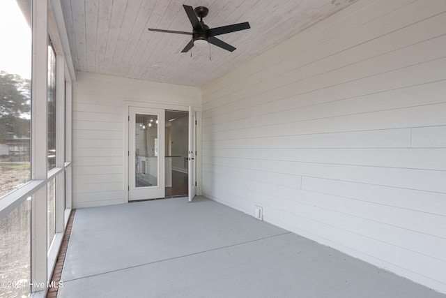 unfurnished sunroom featuring ceiling fan and wood ceiling