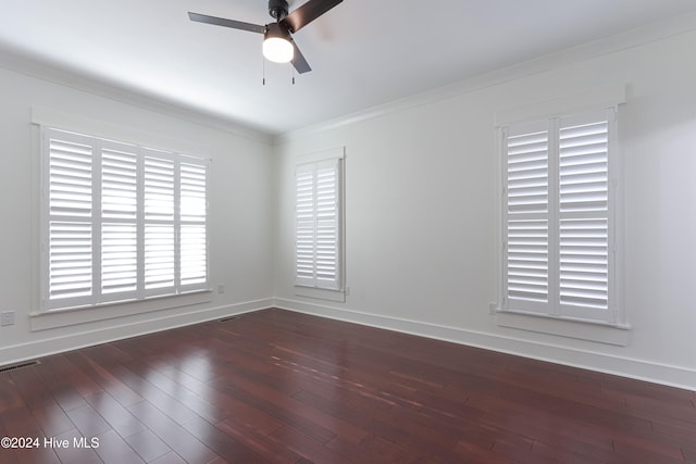 empty room with ceiling fan, dark hardwood / wood-style floors, and ornamental molding