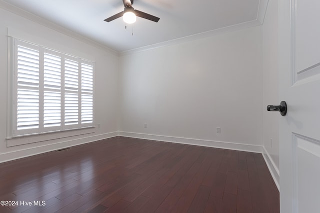 spare room featuring crown molding, ceiling fan, and dark wood-type flooring