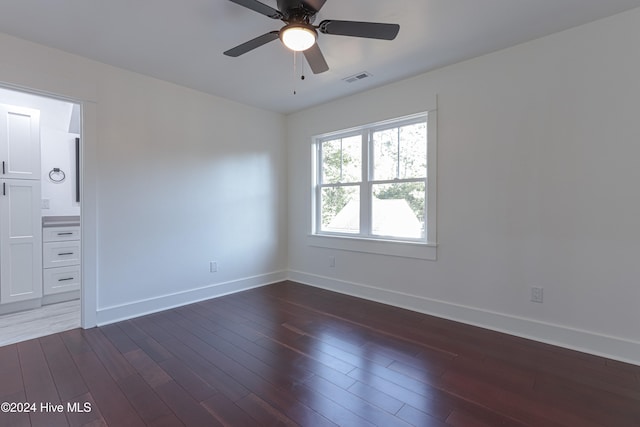 unfurnished room featuring ceiling fan and dark hardwood / wood-style floors