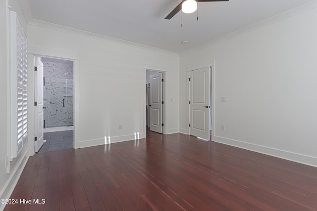 unfurnished bedroom with ensuite bath, ceiling fan, dark hardwood / wood-style flooring, and crown molding