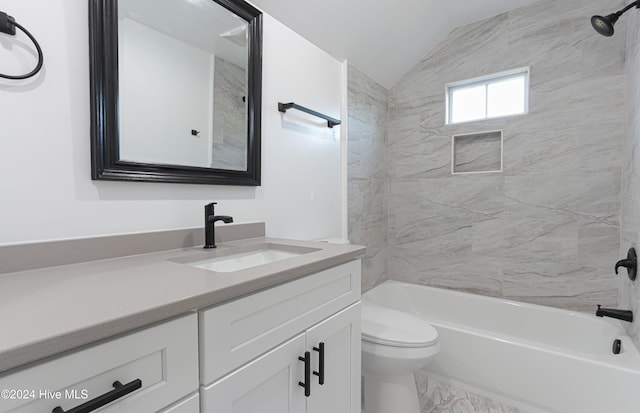 full bathroom with toilet, vanity, vaulted ceiling, and tiled shower / bath