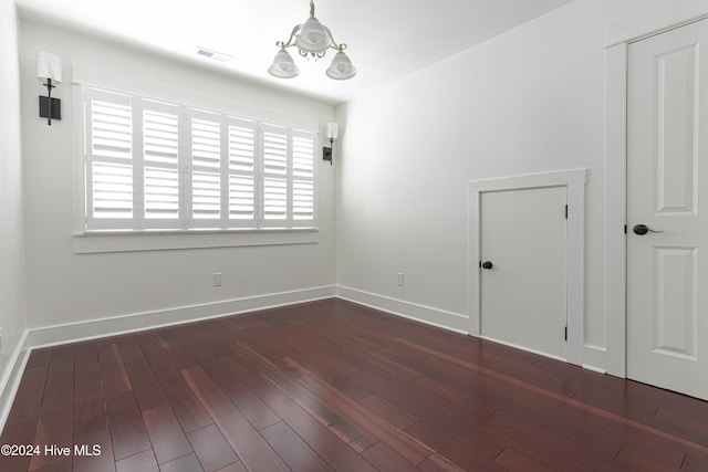 unfurnished room featuring dark wood-type flooring