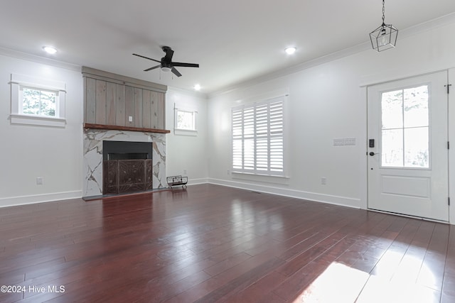 unfurnished living room with plenty of natural light and dark hardwood / wood-style floors