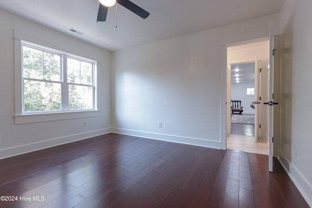 unfurnished room with dark hardwood / wood-style floors and ceiling fan