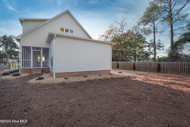 view of home's exterior with a sunroom