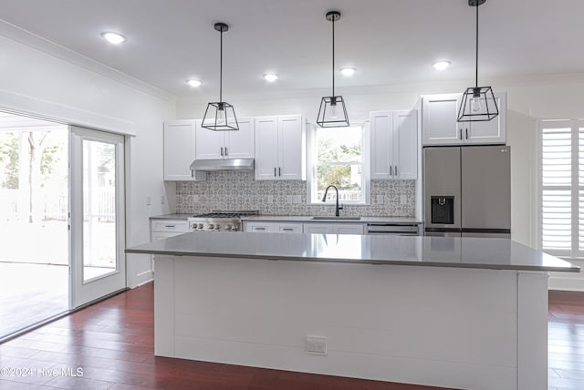 kitchen with white cabinets, a kitchen island, and appliances with stainless steel finishes