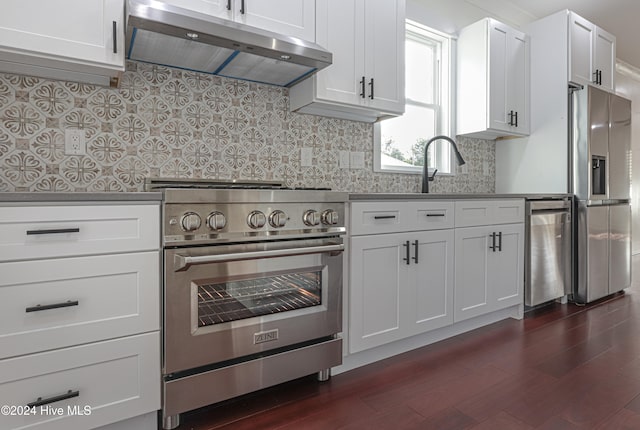 kitchen with white cabinetry, sink, dark wood-type flooring, decorative backsplash, and appliances with stainless steel finishes