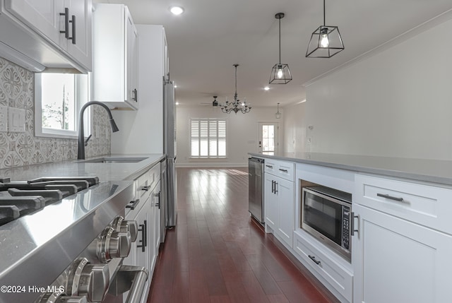 kitchen featuring dark hardwood / wood-style flooring, sink, white cabinets, and appliances with stainless steel finishes