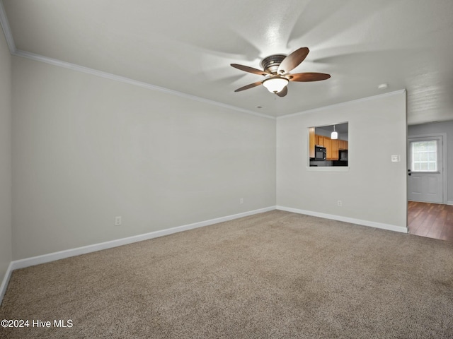 unfurnished room with carpet, ceiling fan, and ornamental molding