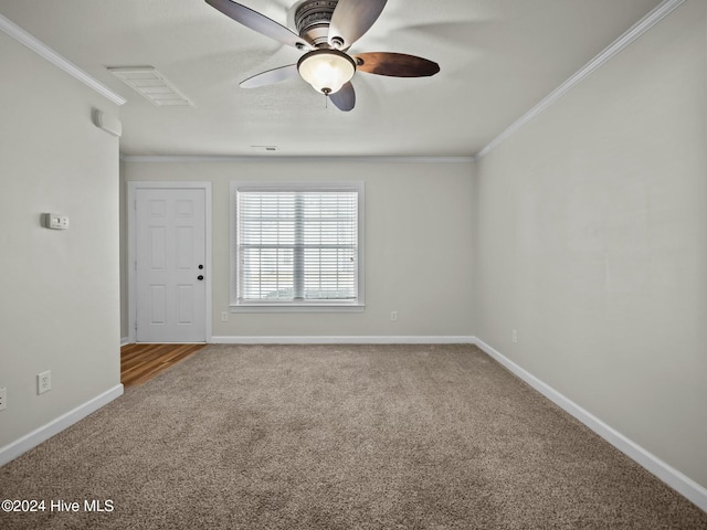 carpeted empty room featuring ceiling fan and ornamental molding