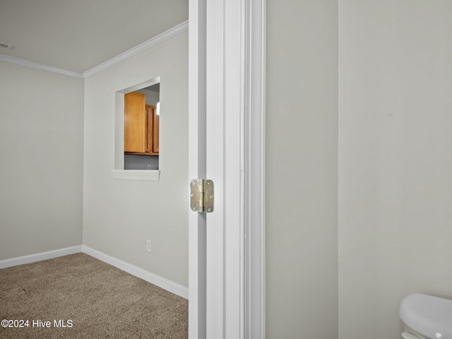 bathroom featuring crown molding and toilet