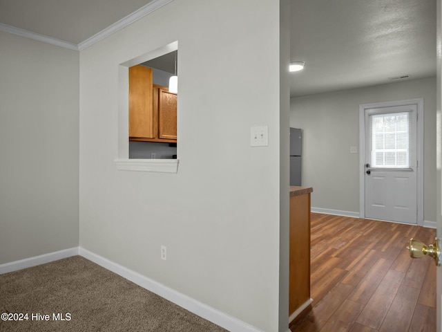 hallway with dark hardwood / wood-style flooring and crown molding