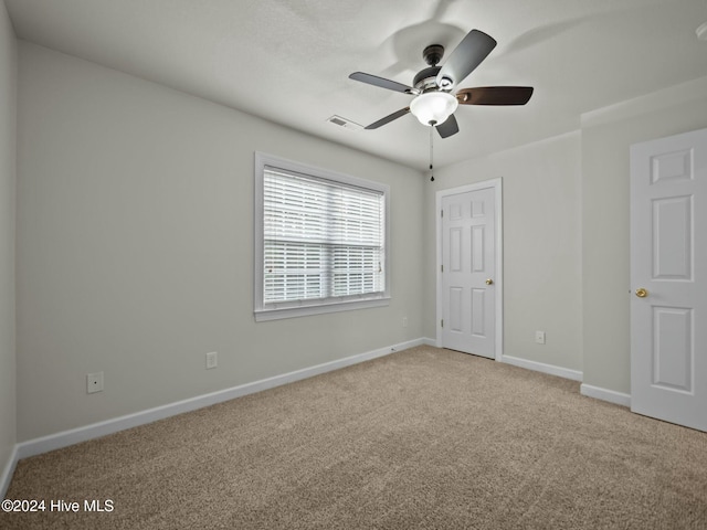 unfurnished bedroom featuring ceiling fan and light colored carpet