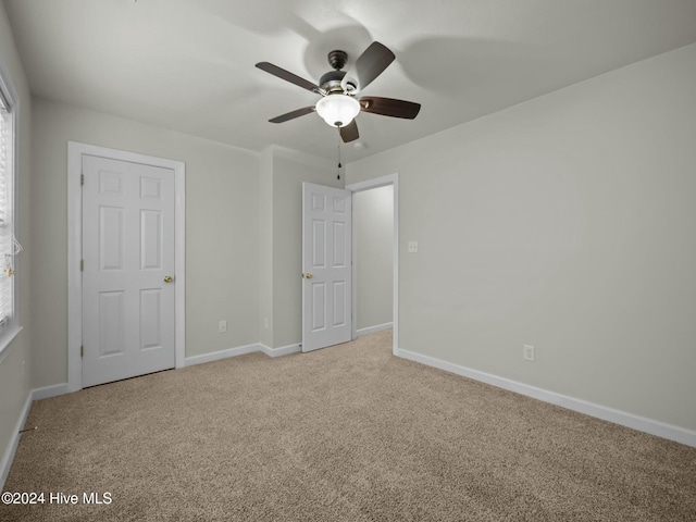 unfurnished bedroom featuring ceiling fan and light carpet