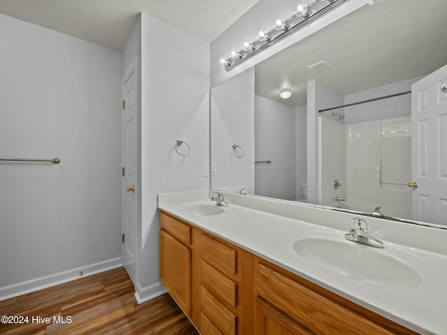 full bathroom with vanity, wood-type flooring, bathtub / shower combination, and toilet