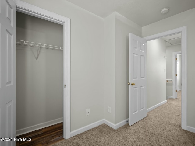 unfurnished bedroom featuring carpet floors and a closet