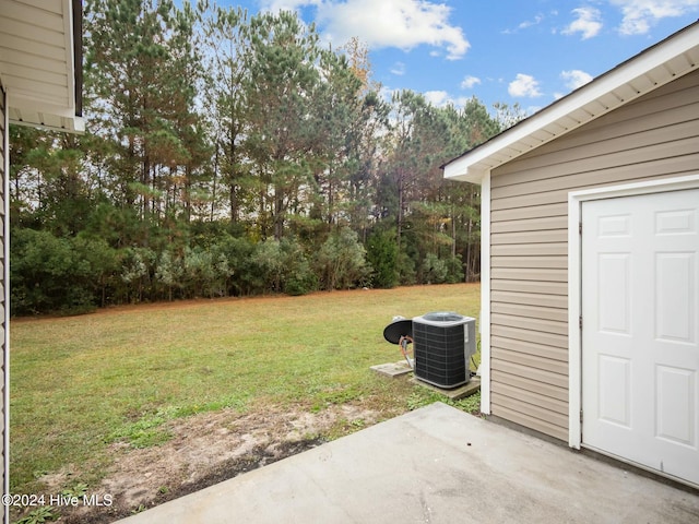 view of yard featuring central air condition unit and a patio area