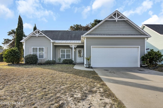 view of front of home featuring a garage and a front lawn