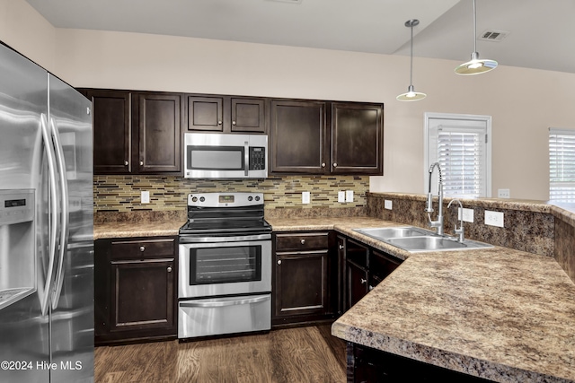 kitchen featuring pendant lighting, sink, dark hardwood / wood-style floors, dark brown cabinets, and stainless steel appliances