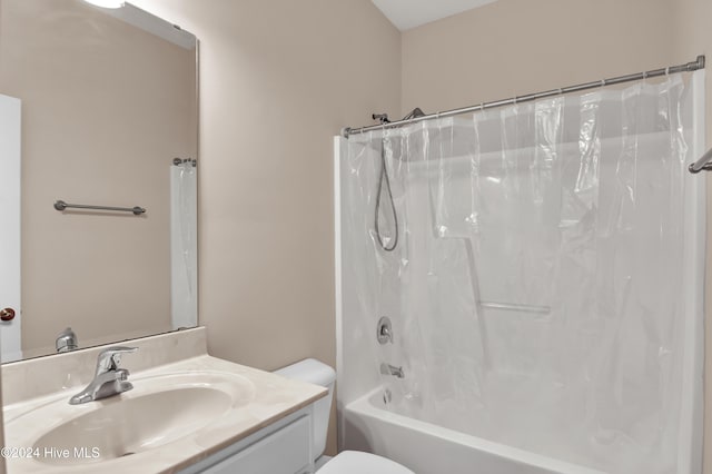 full bathroom featuring shower / tub combo, vanity, and toilet