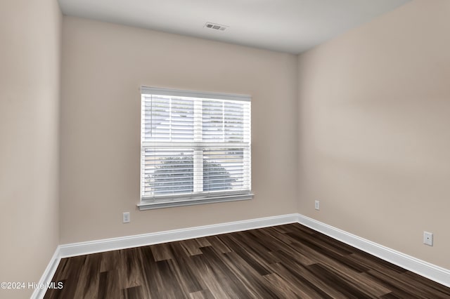 empty room with dark hardwood / wood-style floors