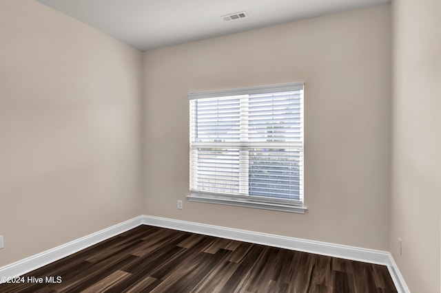 unfurnished room with dark hardwood / wood-style floors