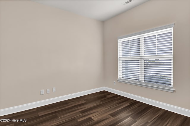 empty room with dark hardwood / wood-style flooring